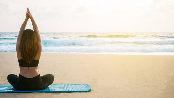 Kobiety grają w jogę. Na plaży W relaksującej koncepcji - Zdjęcie, obraz