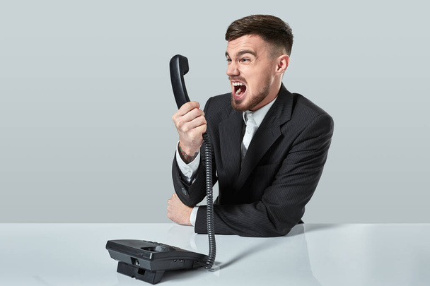 young man dials the phone number while sitting in the office - Foto, immagini