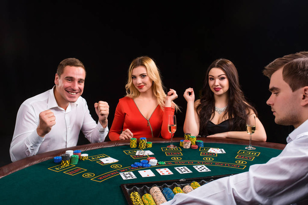 Friends enjoying a gambling night. The dealer deals the cards - Photo, Image