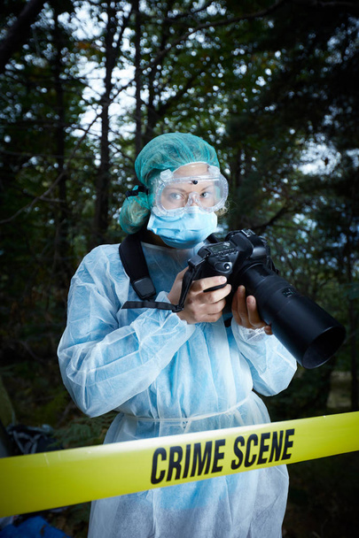 Forensics researcher photographing a blood  at a murder scene - Valokuva, kuva
