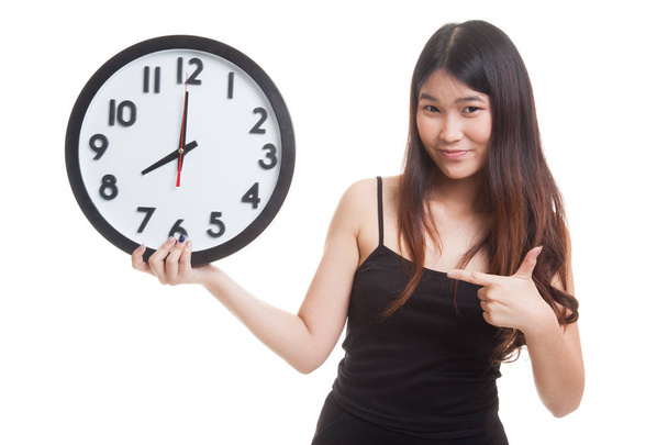 Young Asian woman point to a clock. - Φωτογραφία, εικόνα