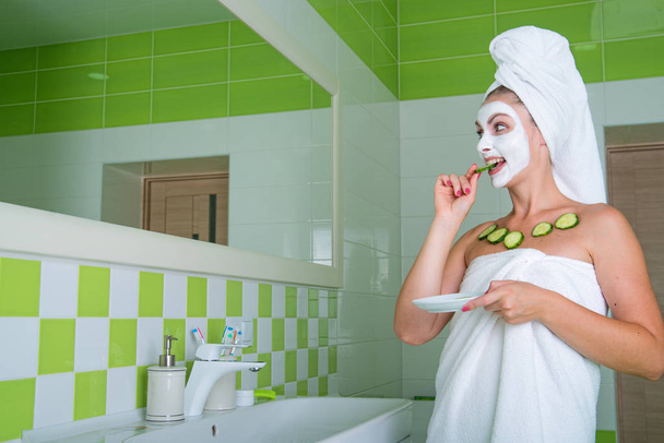 The woman makes a face mask after shower in the morning.Beauty treatments for the skin - Fotó, kép