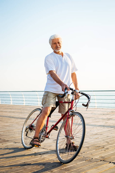 Handsome senior man riding bike  - Photo, Image