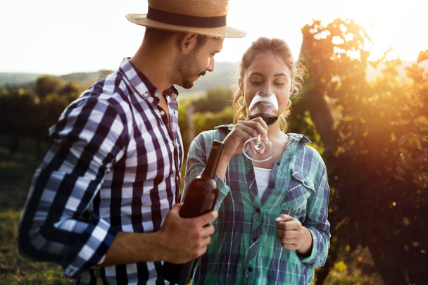 Woman tasting wine in vineyard - Foto, imagen