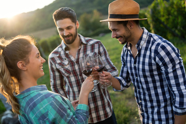 Wine grower and people in vineyard - Фото, зображення