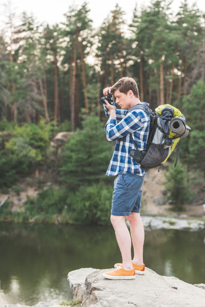 hiker taking photo of lake - Valokuva, kuva