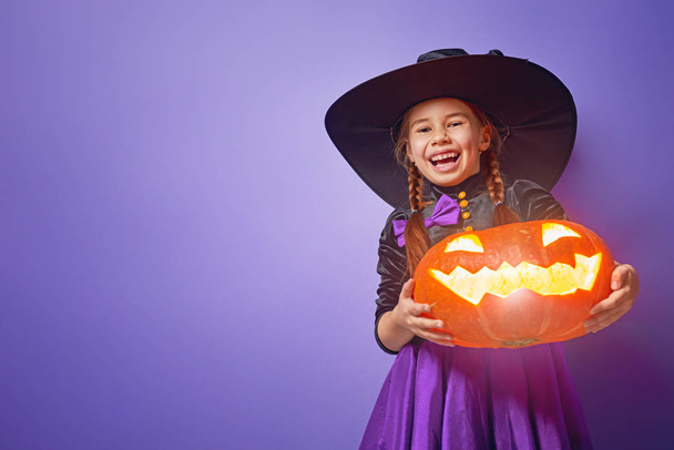 witch with a pumpkin - Фото, зображення