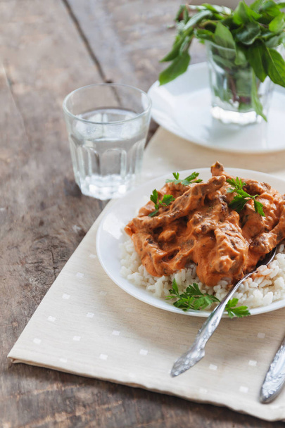 Dish rice with beef stroganoff on a white plate - Photo, Image