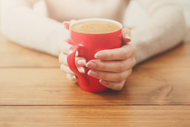 Woman holding a cup of hot drink, close up - Φωτογραφία, εικόνα