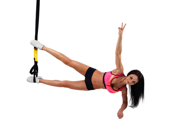 Woman exercising with suspension straps - 写真・画像