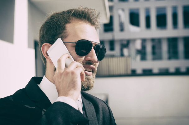Handsome businessman talking on phone city outdoor - Valokuva, kuva