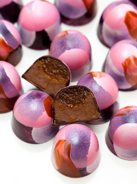 Closeup of chocolate hand painted candy bonbons on a white background. - Photo, Image