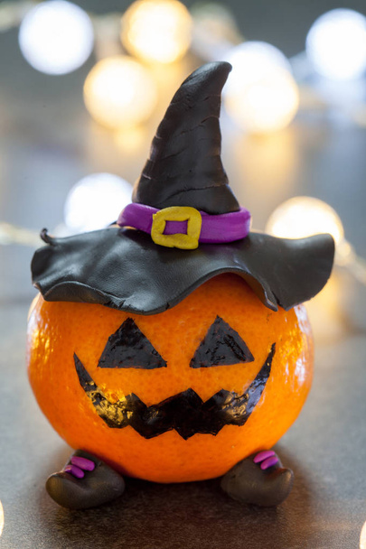 Halloween pumpkin tangerine with black witches hat - Valokuva, kuva