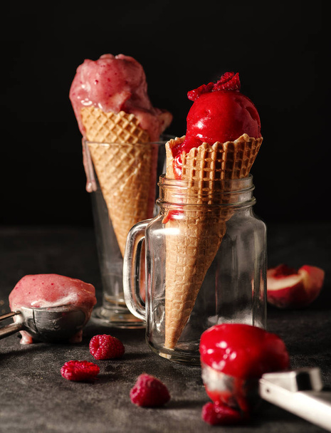 Different sorts of sorbet in waffle cones on a wooden table. - Photo, Image