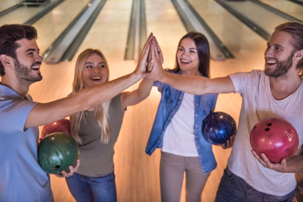 Friends playing bowling  - Фото, зображення