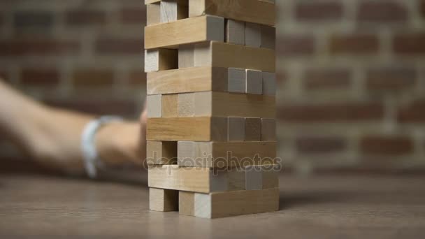 Girl Moves Brick out in Jenga Game - Filmati, video