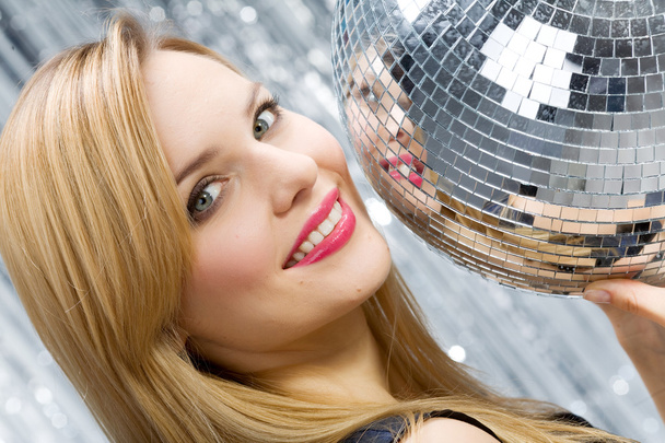 Woman with disco ball over silver backg - Foto, Imagem