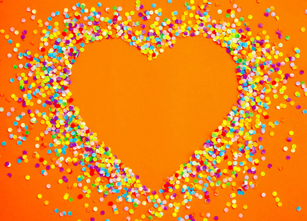 Heart made of colored confetti. - Фото, изображение