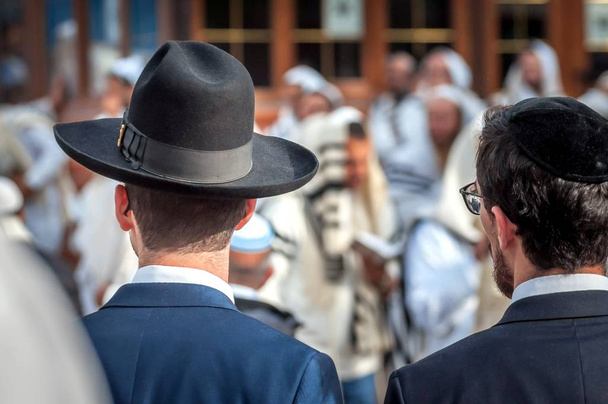 Two adult Hasidim in traditional Jewish headdresses hat and kippah. Prayer of Hasidim. - Photo, Image