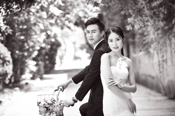 asian wedding couple riding bicycle - Photo, Image