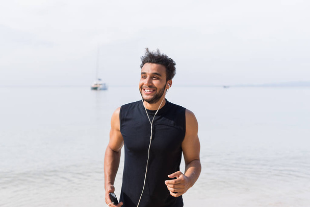 Young Hispanic Man Runner Happy Smiling On Beach Jogging On Seaside Male Latin Sport Fitness Training Outdoors - Foto, immagini