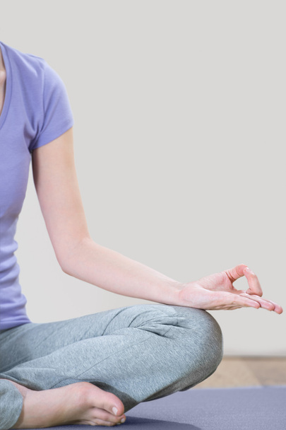 Closeup part of female body meditating. Focus on fingers - Fotografie, Obrázek