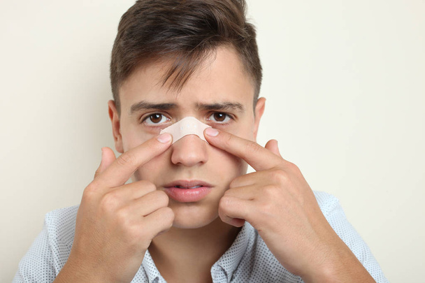  guy with a plaster on his nose - Photo, Image