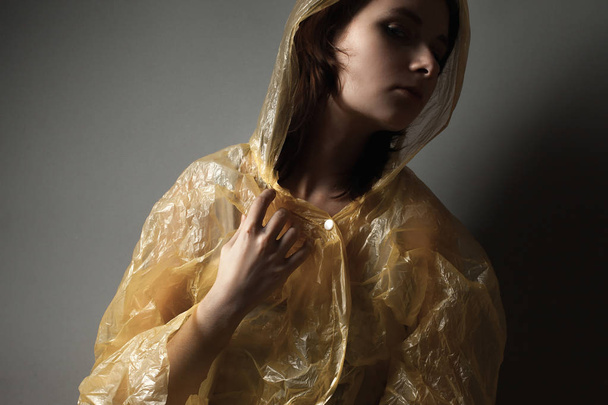 Young woman in raincoat  - 写真・画像