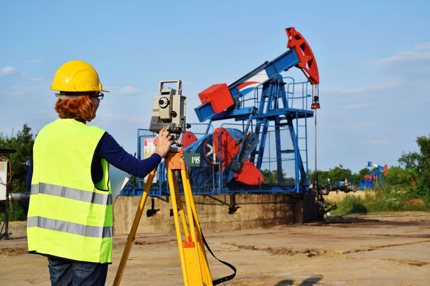 A geodetic engineer on duty on petroleum field - Photo, Image