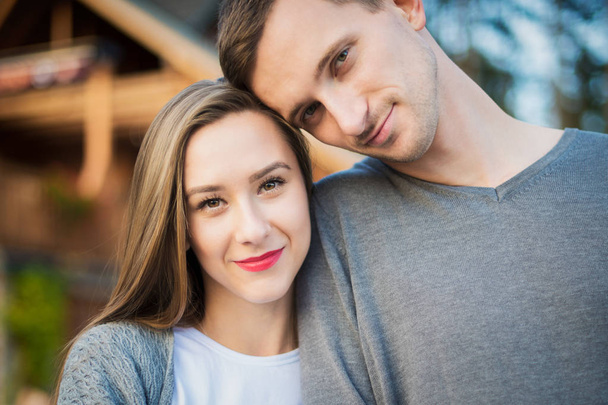 Happy young couple in love hugging. Park outdoors date. Loving couple looking at camera portrait. - Zdjęcie, obraz