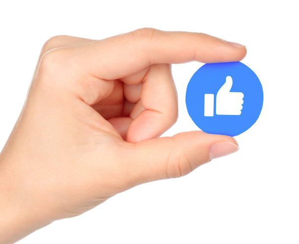 Hand holds Facebook Like Empathetic Emoji Reaction - Foto, imagen