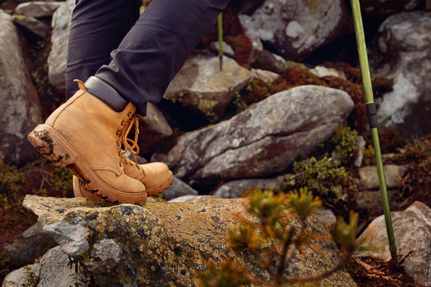 hiking boots on the rock in the mountains. - Photo, Image