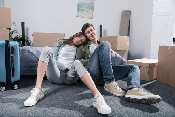 couple sitting on floor at new home - Photo, Image