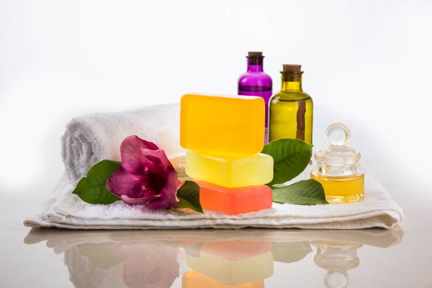 Handmade Ayurvedic Soap with bath and spa accessories. Fresh flowers, precious oils, mortar and towels - Zdjęcie, obraz