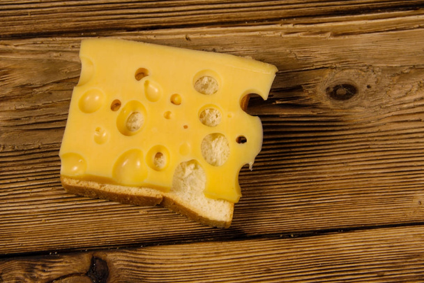 Cheese sandwich on wooden table - Foto, afbeelding