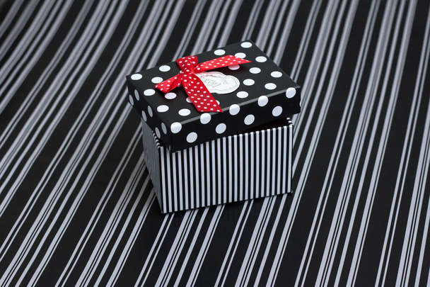 gift box with stripes and peas on a striped background - Fotoğraf, Görsel