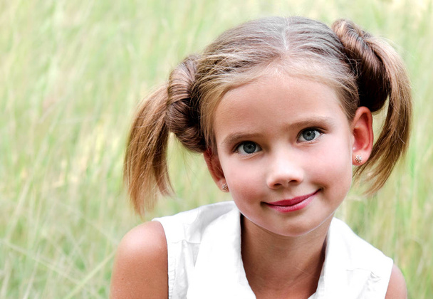 Portrait of adorable smiling little girl child in dress outdoor - Foto, Imagen