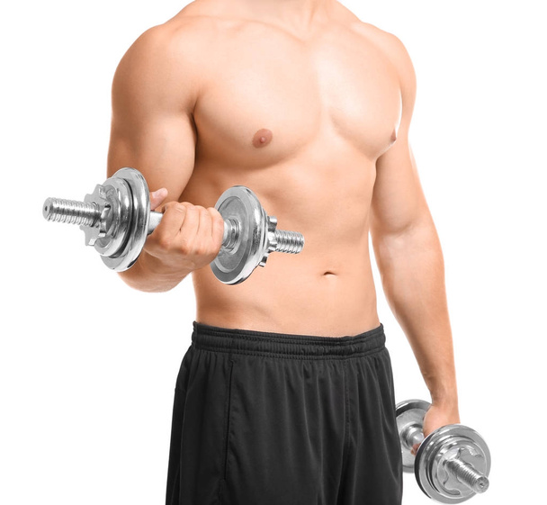 Sporty young man doing exercise with dumbbells on white background - Фото, зображення