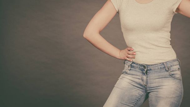 Woman wearing tight slim jeans and white tshirt - 写真・画像