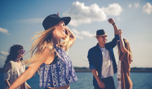Group of friends dancing and celebrating on beach, boho party - Fotoğraf, Görsel