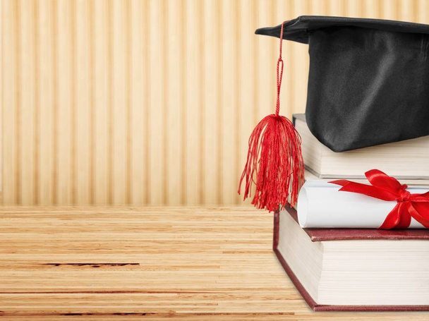 Graduation hat and stacks of books, close-up view  - Fotoğraf, Görsel