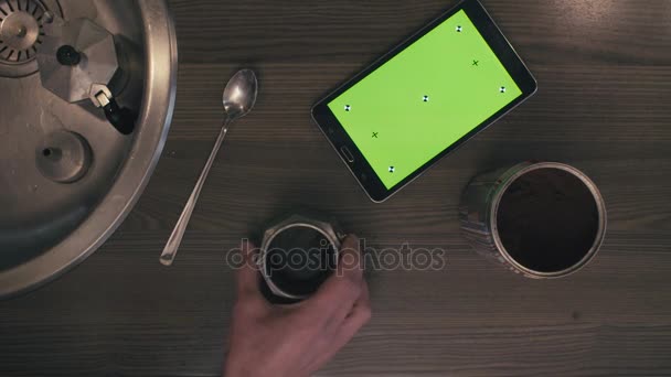 Ένα tablet με πράσινη οθόνη στο τραπέζι της κουζίνας - Πλάνα, βίντεο