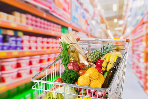 shopping cart full of groceries - Фото, изображение