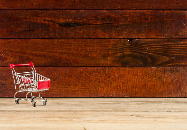 shopping cart on the wooden floor - Foto, imagen