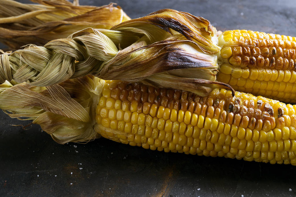 Grilled corn on a black background. - Photo, Image
