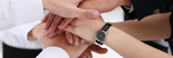 Group of people in suits crossed hands in pile - Photo, Image