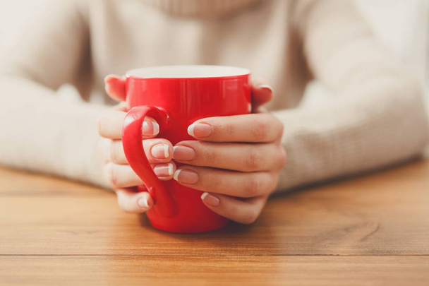 Female holding a cup of hot drink, close up - Foto, Imagem