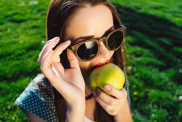 Skeptical fashion woman in glasses.Female with sunglasses,on diet - 写真・画像