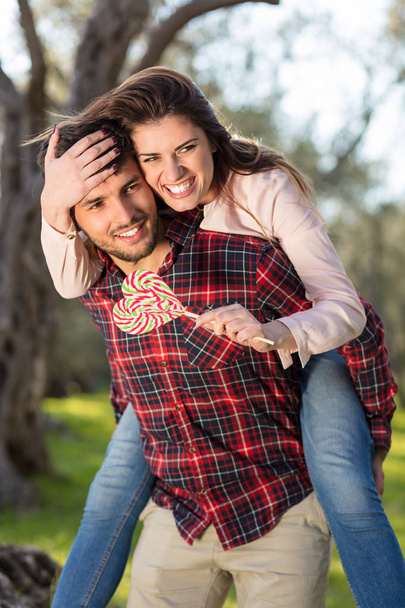 Portrait of a happy young couple in the nature hugged together - 写真・画像