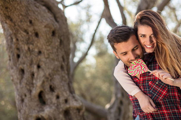 Portrait of a happy young couple in the nature hugged together - Foto, imagen